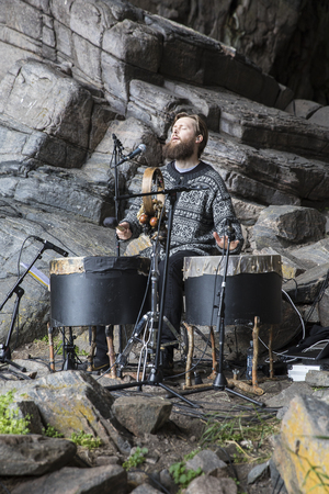 Traena, Norway - July 8 2017: concert of Norwegian band Wardruna at cathedral cave Kirkehelleren on...