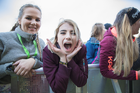 Traena, Norway - July 7 2017: portrait of a young girl screaming during concert of Norwegian rap band Sushi X Kobe at Traenafestival, music festival taking place on the small island of Traenaのeditorial素材
