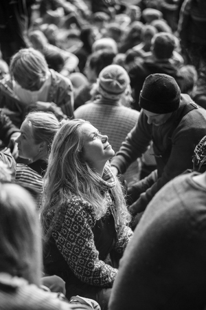 Traena, Norway - July 8 2017: girl in audience watching up at the cave during concert of Norwegian band Wardruna at cathedral cave Kirkehelleren on Sanna Island, at Traenafestival, music festival taking place on the small island of Traena.のeditorial素材