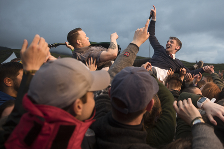Traena, Norway - July 6 2017: singer of Norwegian punk rock band Honningbarna crowd surfing at Traenafestival, music festival taking place on the small island of Traenaのeditorial素材