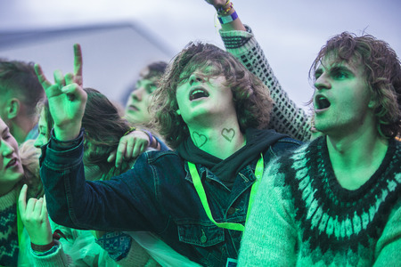 Traena, Norway - July 6 2017: audience cheering, clapping and dancing at concert of Norwegian punk rock band Honningbarna at Traenafestival, music festival taking place on the small island of Traenaのeditorial素材