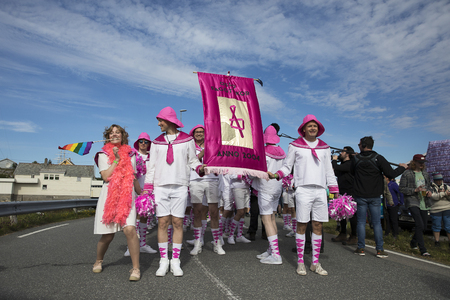Traena, Norway - July 07 2017: men from the choir Oslo Fagottkor in their pink uniform participating in the Traena gay Pride during Traenafestival, music festival taking place on the small island of Traenaのeditorial素材