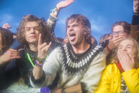 Traena, Norway - July 6 2017: audience cheering, clapping and dancing at concert of Norwegian punk rock band Honningbarna at Traenafestival, music festival taking place on the small island of Traenaのeditorial素材