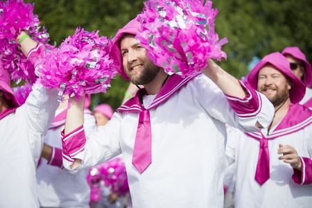 Traena, Norway - July 07 2017: men from the choir Oslo Fagottkor in their pink uniform participating in the Traena gay Pride during Traenafestival, music festival taking place on the small island of Traenaのeditorial素材