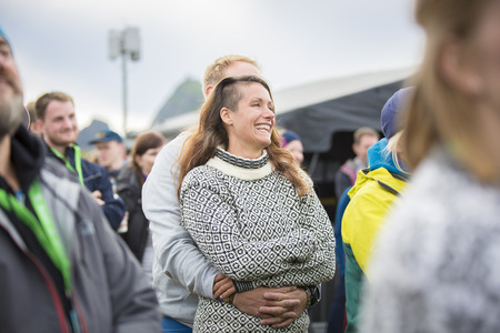 Man and woman hugging with emotion in the audience during the concert of Norwegian choir Oslo Fagittkor at Traena festival, music festival taking place on the small island of Traenaのeditorial素材