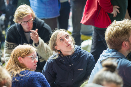 Traena, Norway - July 8 2017: girl in audience watching up at the cave during concert of Norwegian...