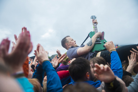 Traena, Norway - July 6 2017: singer of Norwegian punk rock band Honningbarna crowd surfing at Traenafestival, music festival taking place on the small island of Traenaのeditorial素材