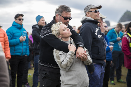 Man and woman hugging with emotion in the audience during the concert of Norwegian gay choir Oslo Fagittkor at Traena festival, music festival taking place on the small island of Traenaのeditorial素材