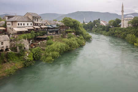 Mostar, Bosnia and Herzegovina - 20 May 2016: Old town, Koski Mehmed Pasa mosque and Neretva River. The old town was destroyed during the Croat-Bosniak war in 1993, reconstructed and now a World Heritage UNESCO siteのeditorial素材