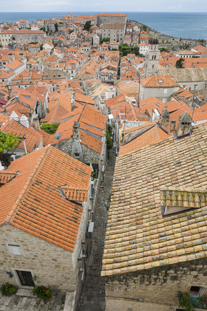 View over the orange rooftops of old town Dubrovnik from the ancient city wall with cloudy weather, Croatiaの写真素材
