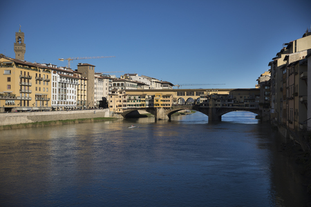 Sunny view on the Arno River and Ponte Vecchio in Florence, Italyの写真素材