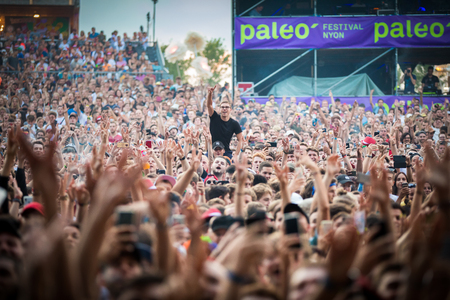 Nyon, Switzerland - 26 July 2019 :  crazy crowd of young poeple cheering and dancing at concert of Congolese-Belgian rap singer Damsoのeditorial素材