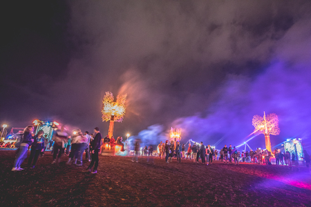 Nyon, Switzerland - 27 July 2019 :  festival field at night with people hanging around sitting on the art structure designed by collective "Monic la Mouche"のeditorial素材
