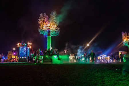 Nyon, Switzerland - 27 July 2019 :  festival field at night with people hanging around sitting on the art structure designed by collective "Monic la Mouche"のeditorial素材