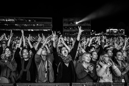 Nyon, Switzerland - 27 July 2019 :  very happy and excited young women in the audience, cheering, clapping and jumping at concert of French pop singer Patrick Bruelのeditorial素材
