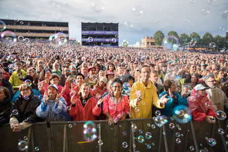 Nyon, Switzerland - 27 July 2019 : crowd of audience cheering in the middle of sop bubbles at concert of Swiss pop singer Stephan Eicher & Traktorkestarのeditorial素材
