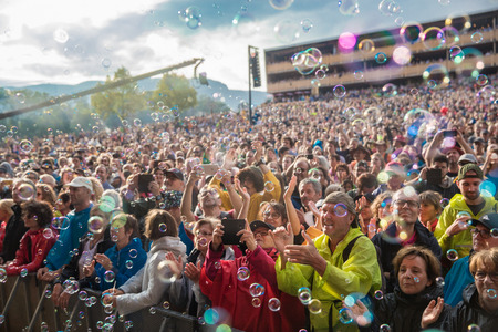 Nyon, Switzerland - 27 July 2019 : crowd of audience cheering in the middle of sop bubbles at concert of Swiss pop singer Stephan Eicher & Traktorkestarのeditorial素材