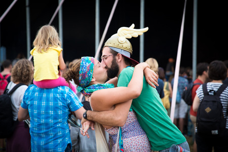 Nyon, Switzerland - 26 July 2019 :  man and woman hugging and kissing during a concert, the man is wearing a Winged Gaul Helmetのeditorial素材