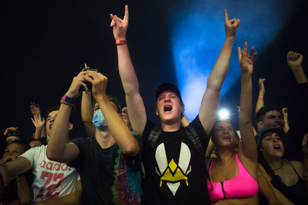 Nyon, Switzerland - 25 July 2019 :  young people in the audien cheering up arms up in the air in front of concert of French rap singer Moha la Squaleのeditorial素材