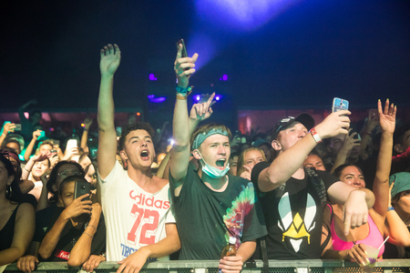 Nyon, Switzerland - 25 July 2019 :  young people in the audien cheering up arms up in the air in front of concert of French rap singer Moha la Squaleのeditorial素材