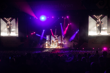 Nyon, Switzerland - 24 July 2019 :  general view on the main stage with crowd of audience at concert of extravagant French singer-songwriter and guitarist Matthieu Chedid called âM-のeditorial素材