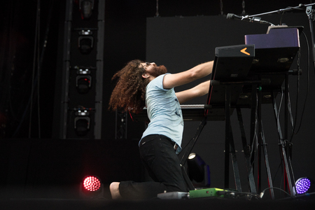 Nyon, Switzerland - 24 July 2019 :  concert of Australian singer-songwriter and multi-instrumentalist Xavier Rudd, pianist is playing on his kneeのeditorial素材