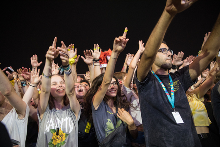 Nyon, Switzerland - 23 July 2019: audience of young people cheering in front of concert of American...