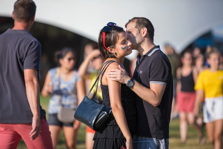Nyon, Switzerland - 23 July 2019:  man and woman in love, couple of festival-goers kissing at paleo festivalのeditorial素材
