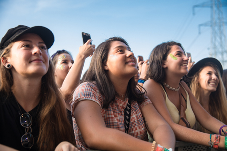 Nyon, Switzerland - 23 July 2019 : group of girls in the audience crowed cheering during concert of Australian singer-songwriter and multi-instrumentalist Tash Sultana at Paleo Festivalのeditorial素材