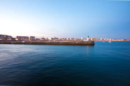 Entrance of Les Sables D'Olonne harbour taken from La Chaume, with it piers and lighthouse at sunset, Vendee, Franceの写真素材
