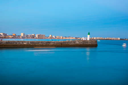 Entrance of Les Sables D'Olonne harbour taken from La Chaume, with it piers and lighthouse at sunset, Vendee, Franceの写真素材