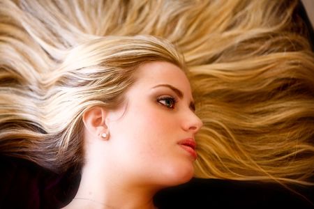 Female with long blonde hairs radiatingの写真素材