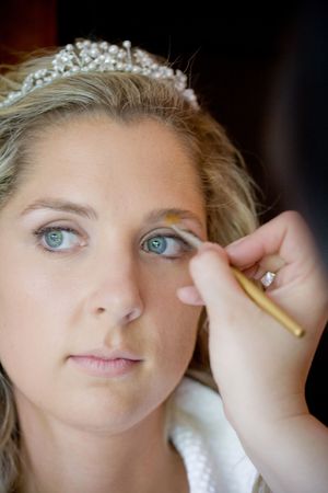 A bride is having her make up done by an artistの写真素材