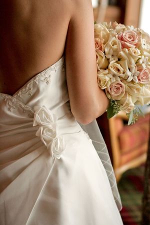 A back view of a bride with her bouquetの写真素材