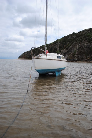 Sailing Boat on the Water in low tideの写真素材