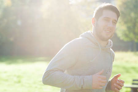 Young man in park runningの写真素材