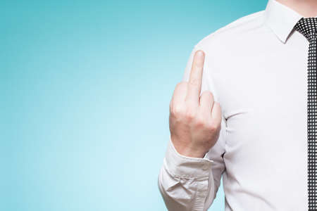 Man wearing shirt and tie shows middlefingerの写真素材