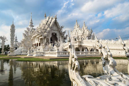 White temple and reflection over cloudy sky の写真素材