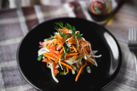 Vitamin fresh vegetable salad julienne on a black plate, close-upの写真素材