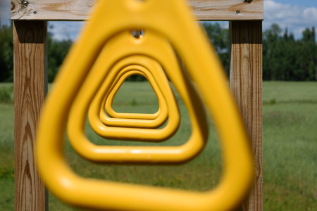 Closeup Looking Through Yellow Monkey Bar Ringsの写真素材