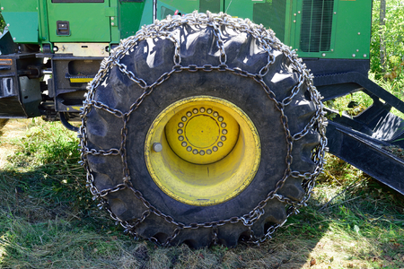 Tire on Green Log Skidderの写真素材