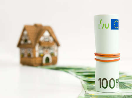 Way to the miniature house is laid out from banknotes of euro.の写真素材