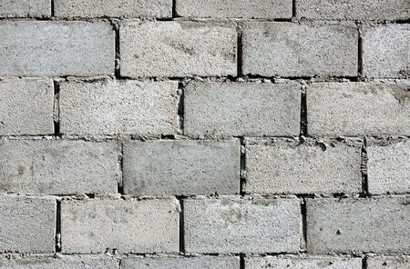 Fragment gray dirty weathered brick wall