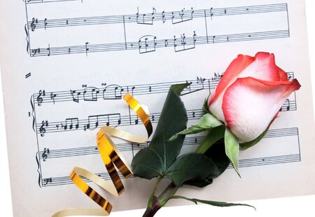 Closeup fresh rose with a tape on a musical paperの写真素材