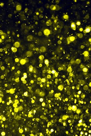 Golden celebratory background from defocus movement bubblesの写真素材