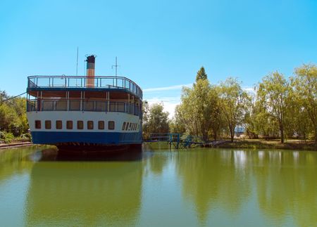 Old thrown steamship costs on coast of lakeの写真素材