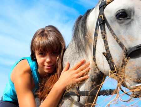 Beautiful girl riding a horse on natureの写真素材