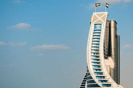 DUBAI, UAE - December 10, 2013  Jumeirah Beach Hotel, preceded by beachfront  Well-known for its wave-shaped silhouette, remains one of the best recognizable landmarks of Dubai, UAEのeditorial素材