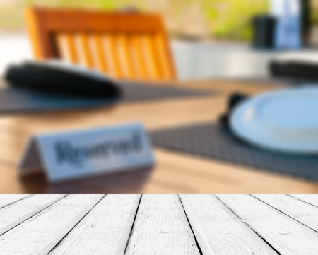 Empty wooden deck table with copyspace and bokeh background 