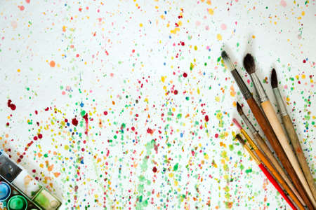 Tray of paints on spotted by paints paperの写真素材